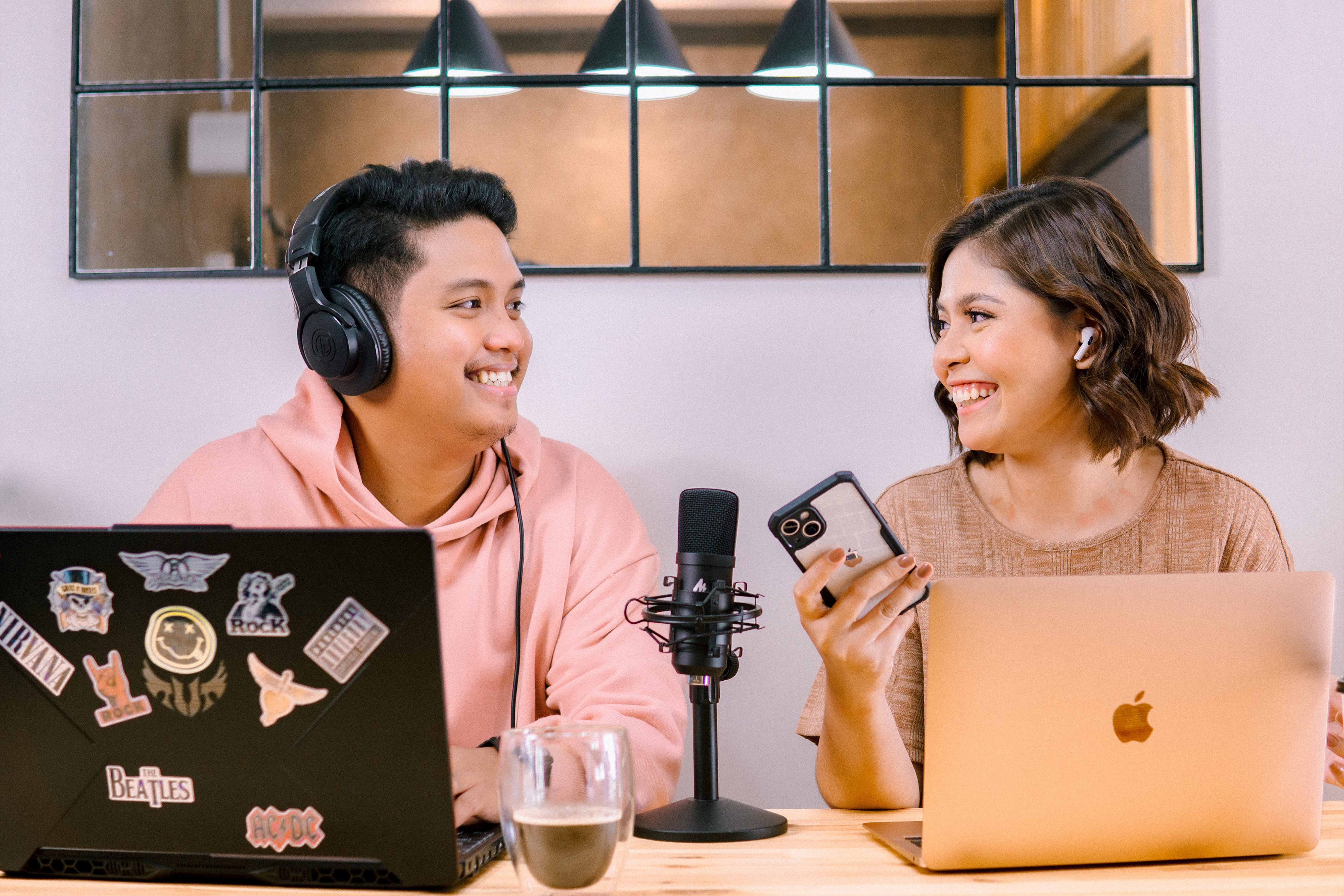 Two People Wearing Headphones Smiling